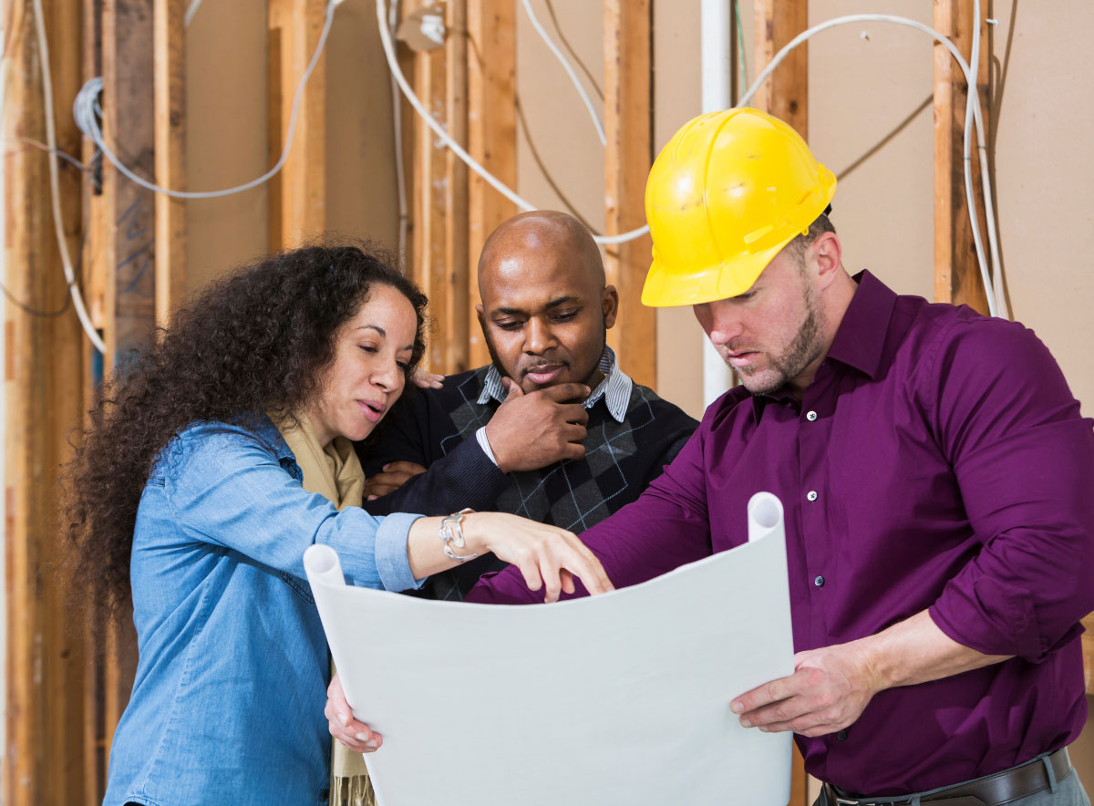 Child care center business owners discussing building design with contractor