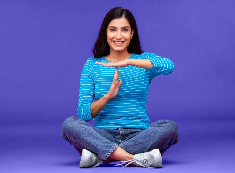 woman-smiling-time-out-hand-sign