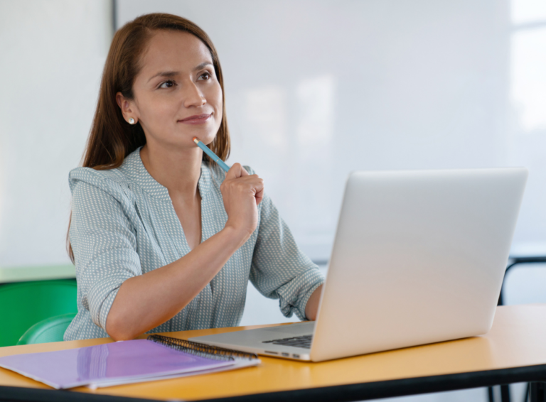 Child care teacher with laptop thinking about first day of class