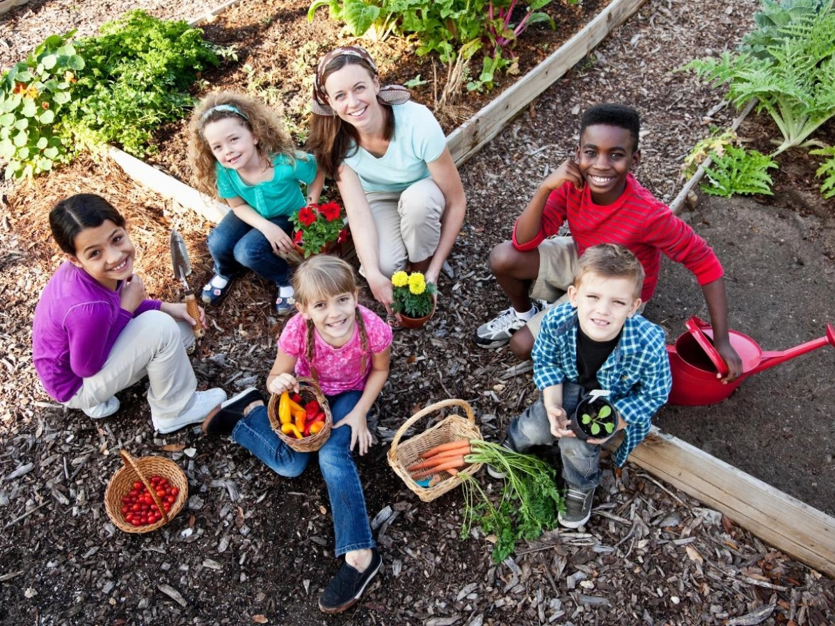 Woman and children gardening for community outreach activity