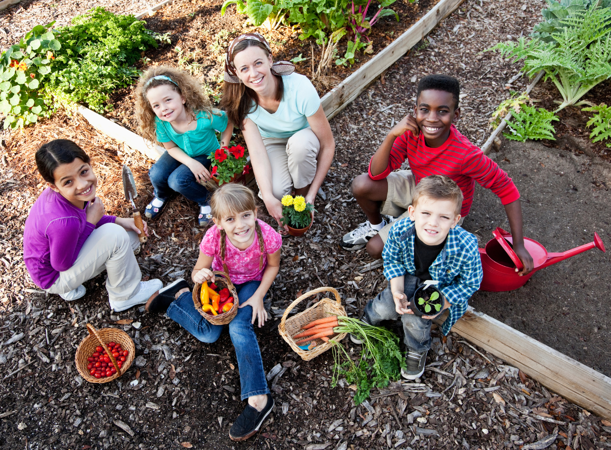 Woman and children gardening for community outreach activity