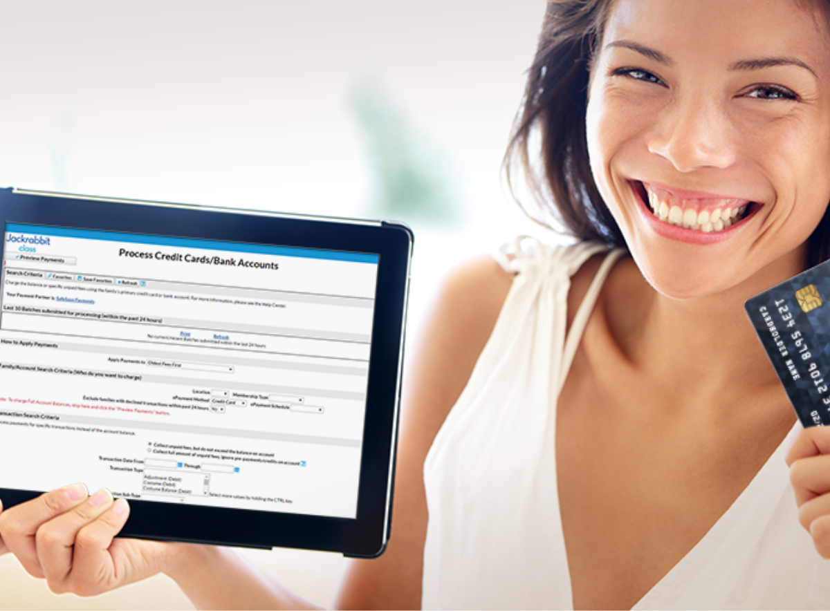 Woman smiling holding tablet and credit card for an epayment transaction