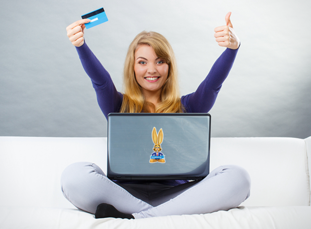 women-sitting-smiling-thumbs-up-credit-card