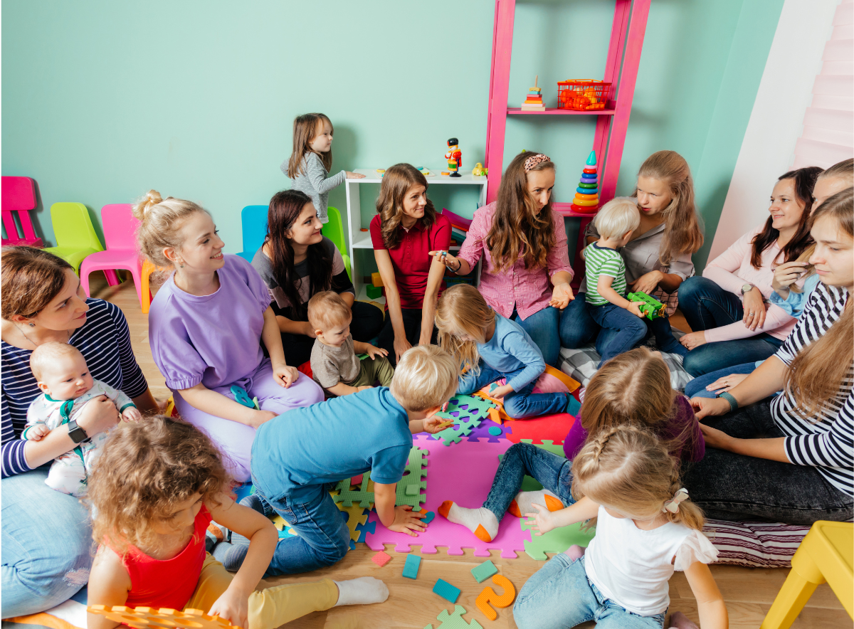 Parents and children in a child care center talk, play and share ideas