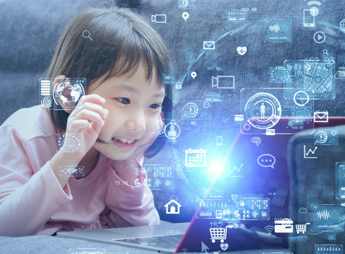 Young girl lays in front of a laptop facinated with flying swirling icons