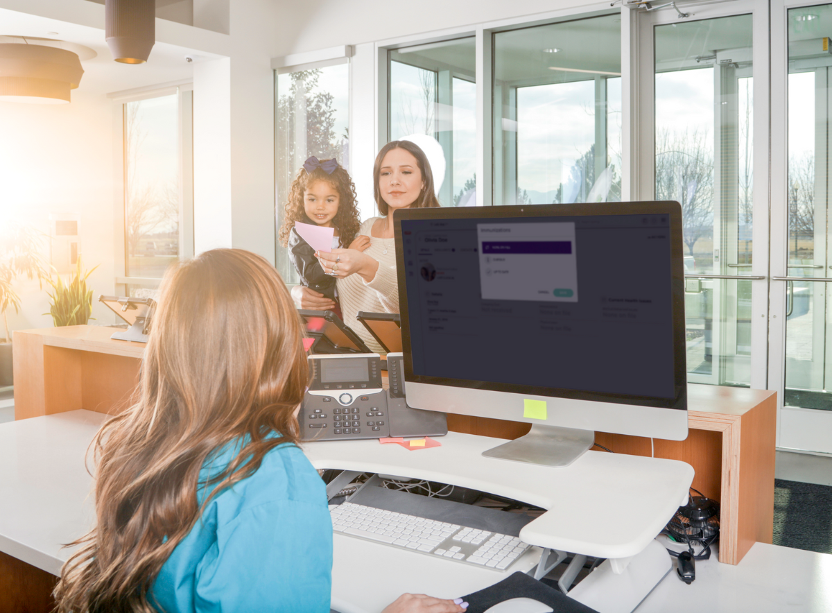 Mother and child at child care center check in using management software