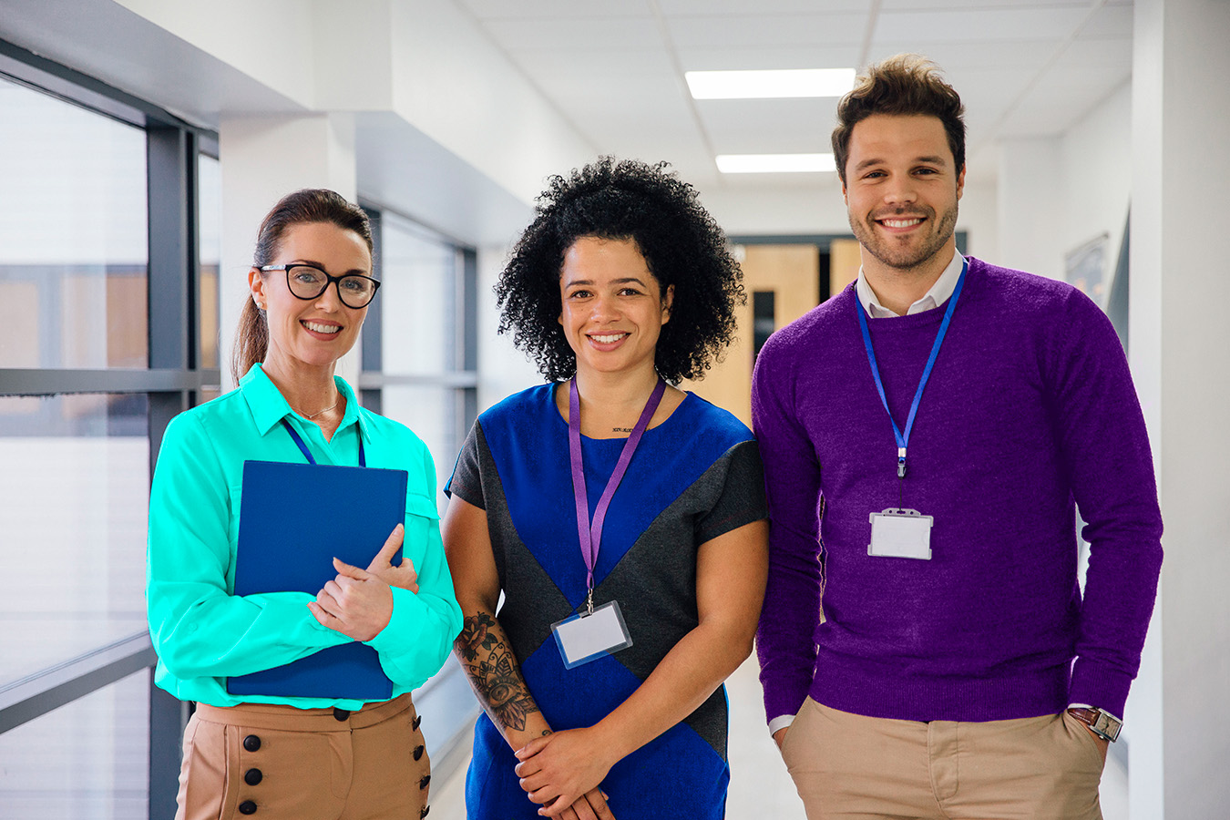 3 child care teachers smile.