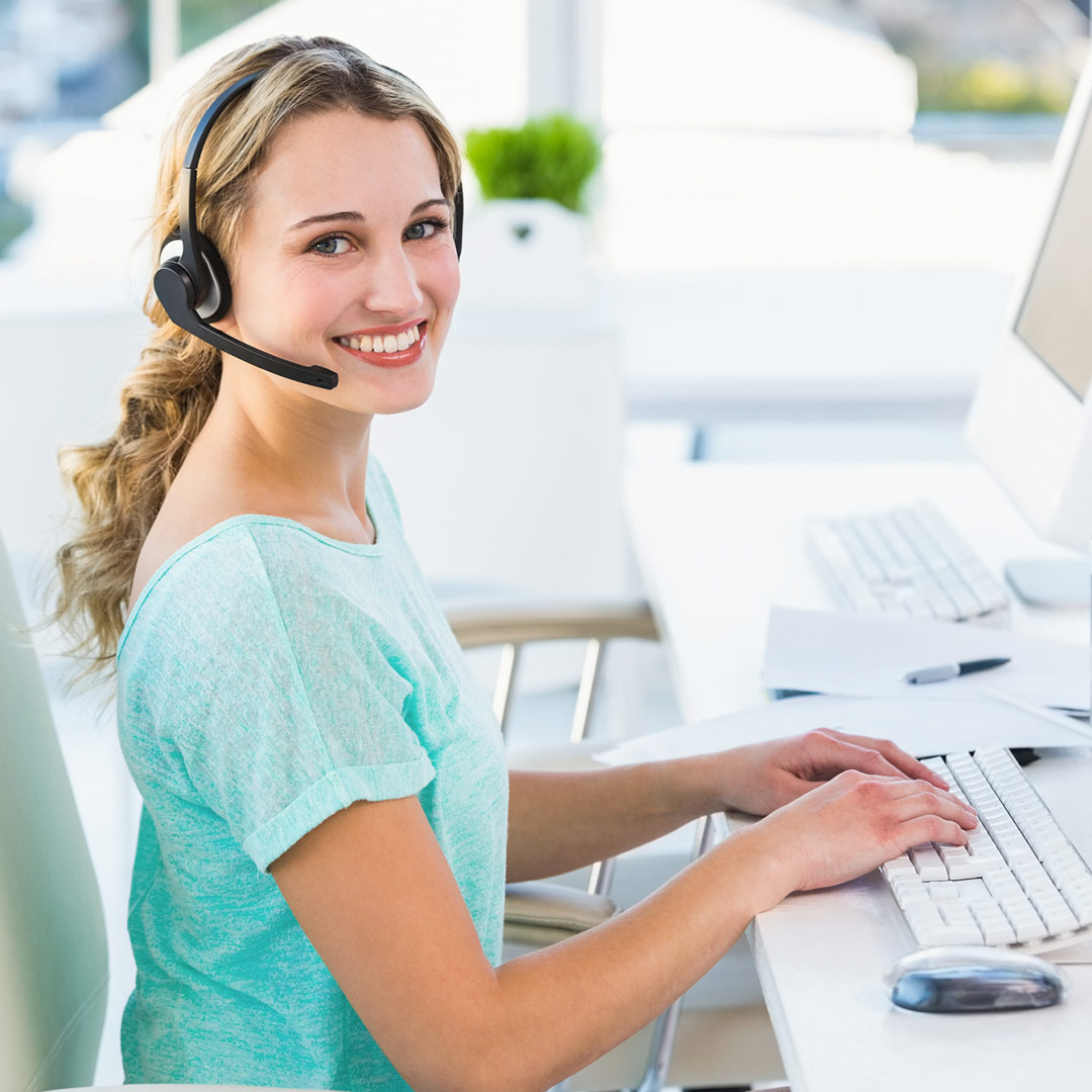 woman on laptop with headset