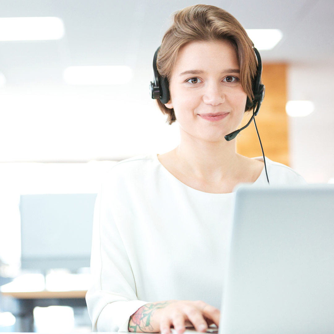 woman on laptop with headset