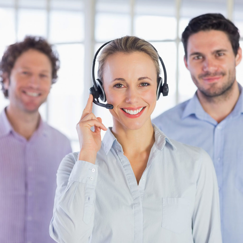 woman with headset and two men