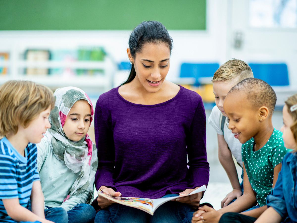 Teacher reads a story to a group of children